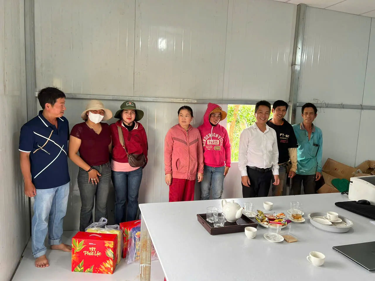 The team with their Tết gifts at the office